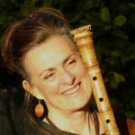 Anne smiles with shakuhachi